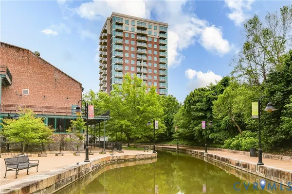 a view of swimming pool with outdoor seating and plants