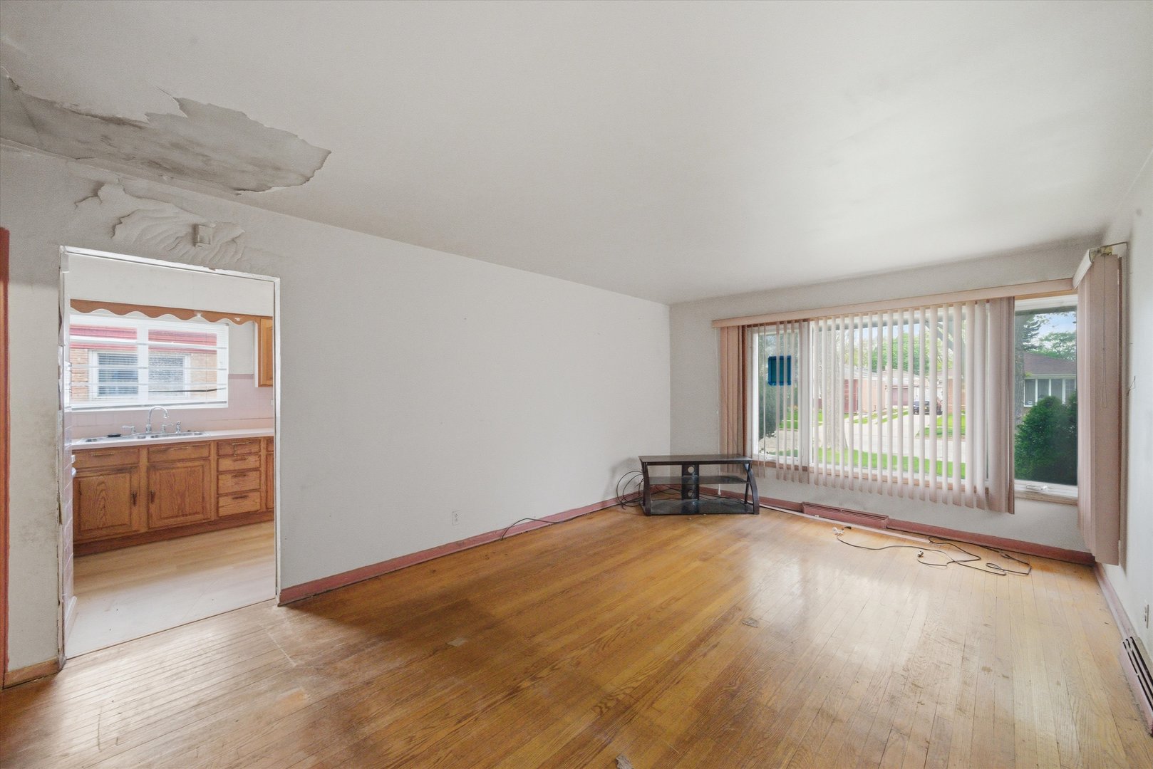 119 Rice Avenue Bellwood, IL 60104 - Photo 2 of 25 wooden floor in an empty room with a window