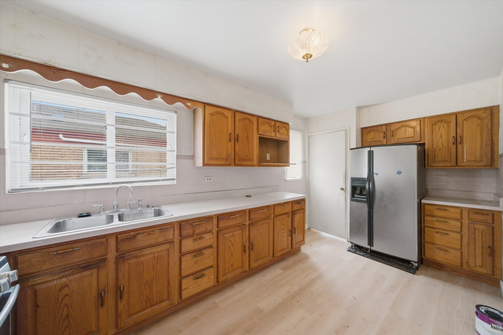 119 Rice Avenue Bellwood, IL 60104 - Photo 6 of 25 a kitchen with stainless steel appliances granite countertop a refrigerator and a sink