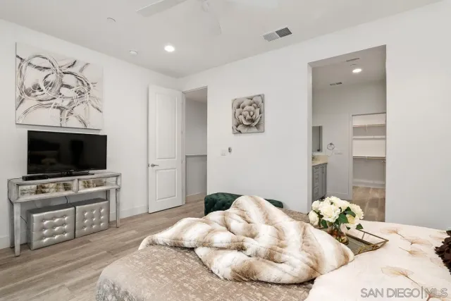 a bedroom with a bed and a flat screen tv