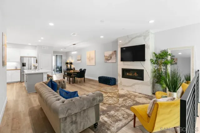 a living room with furniture a fireplace and a flat screen tv