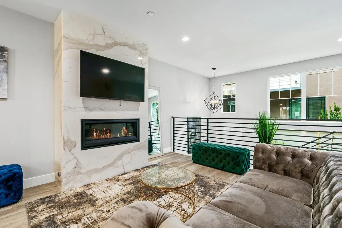347 Oak Avenue Carlsbad, CA 92008 - Photo 17 of 34 a living room with a couch a flat screen tv and a fireplace