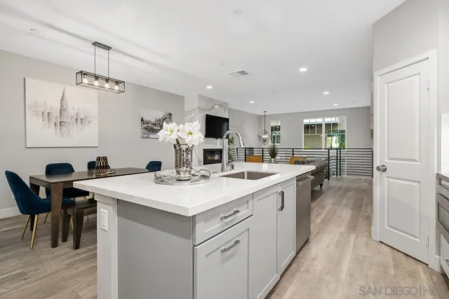 a kitchen with a sink and chairs