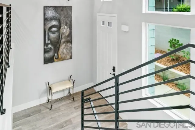 a view of staircase with furniture and a window