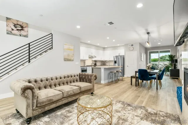 a living room with furniture and kitchen view