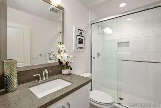a bathroom with a sink toilet and shower