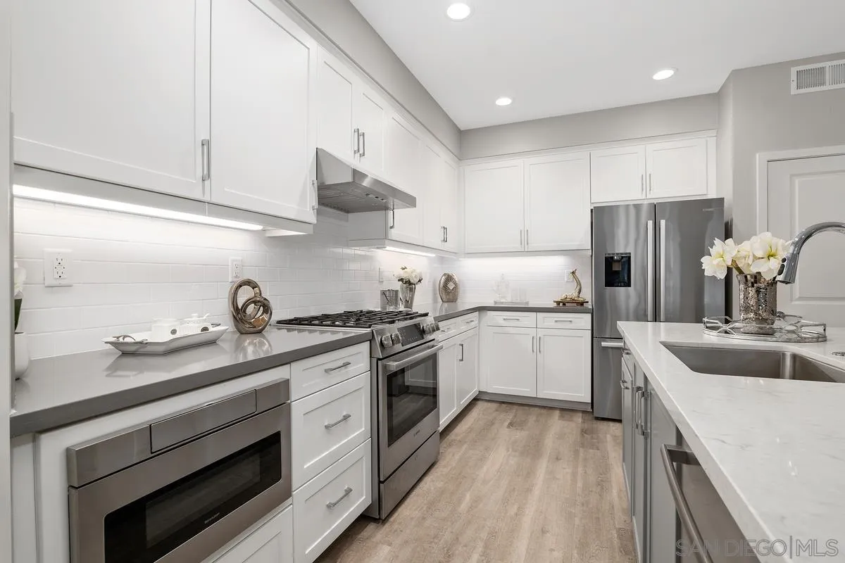 347 Oak Avenue Carlsbad, CA 92008 - Photo 4 of 34 a kitchen with stainless steel appliances granite countertop a sink stove and refrigerator