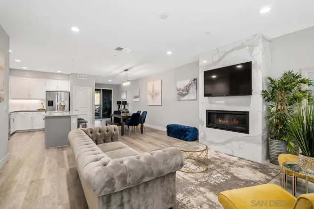 a living room with furniture a fireplace and a flat screen tv