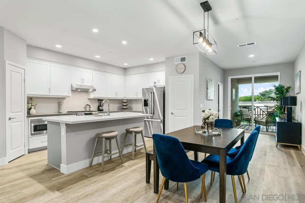 347 Oak Avenue Carlsbad, CA 92008 - Photo 7 of 34 a kitchen with a dining table chairs stainless steel appliances and cabinets