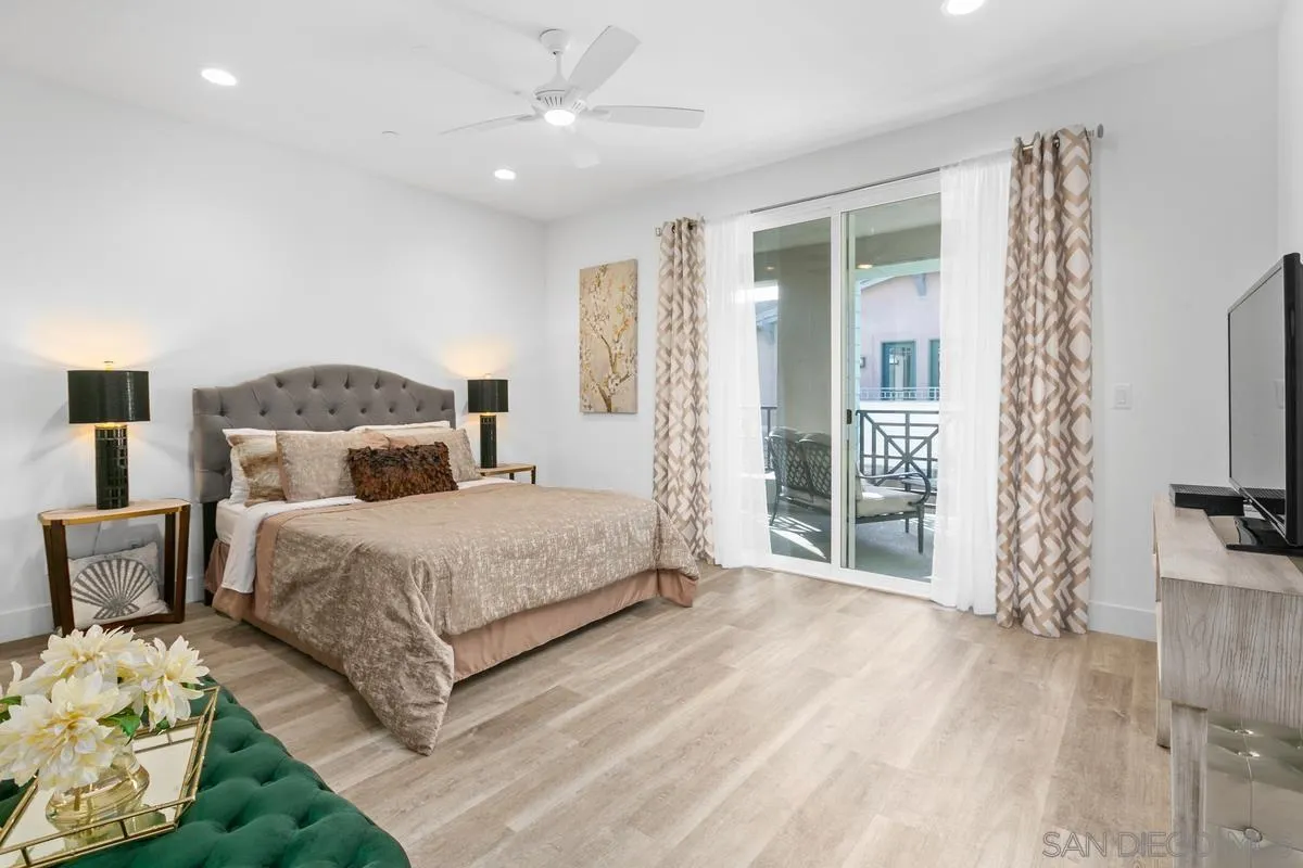 347 Oak Avenue Carlsbad, CA 92008 - Photo 10 of 34 a bedroom with a bed a large window and wooden floor
