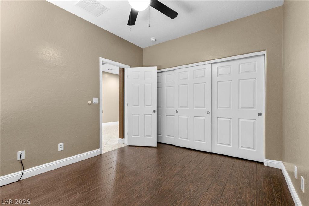 2627 Dirleton Place Henderson, NV 89044 - Photo 28 of 42 Hardwood look tile flooring extends across this spacious bedroom, complemented by convenient bi-fold closet doors.