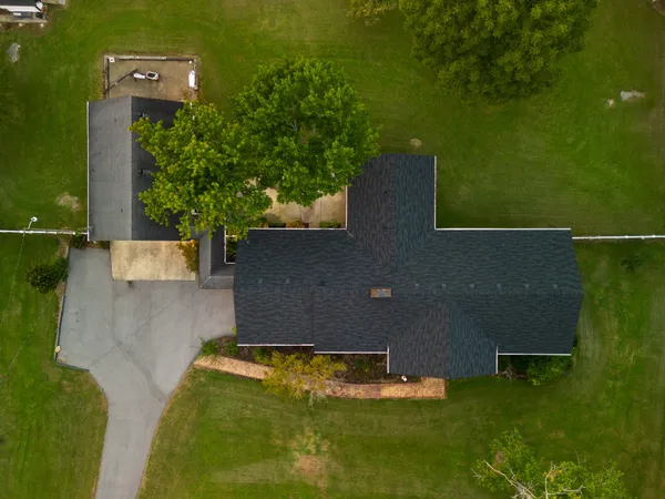 a kitchen with granite countertop a sink a stove and cabinets