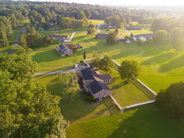 a living room with furniture a fireplace and a chandelier