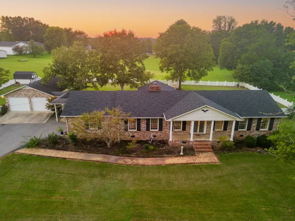 a view of a livingroom with furniture and a window