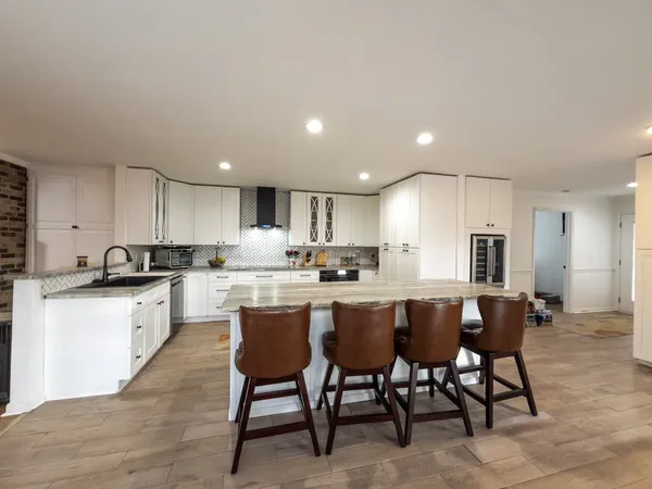 a bedroom with a bed and dresser with mirror