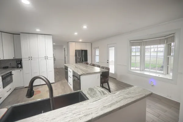 a spacious bathroom with a sink a toilet a mirror and shower