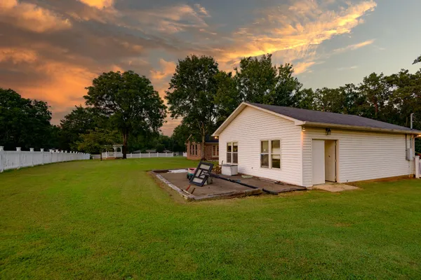 a kitchen with granite countertop a stove sink and cabinets
