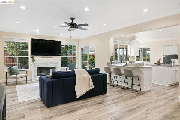 a living room with fireplace furniture and a flat screen tv