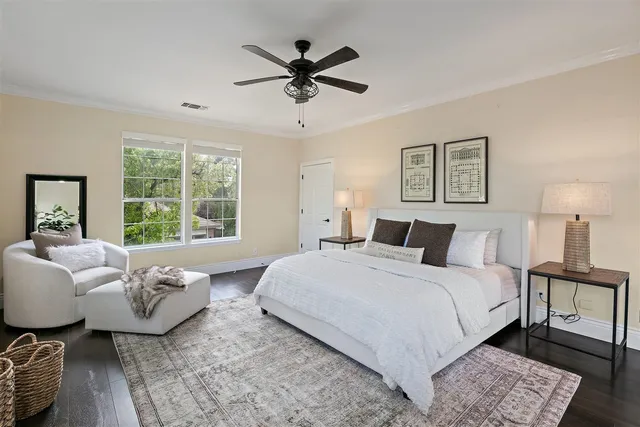 a spacious bedroom with a bed a couch and a window