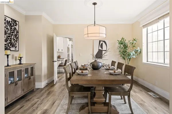 a view of a dining room with furniture window and wooden floor