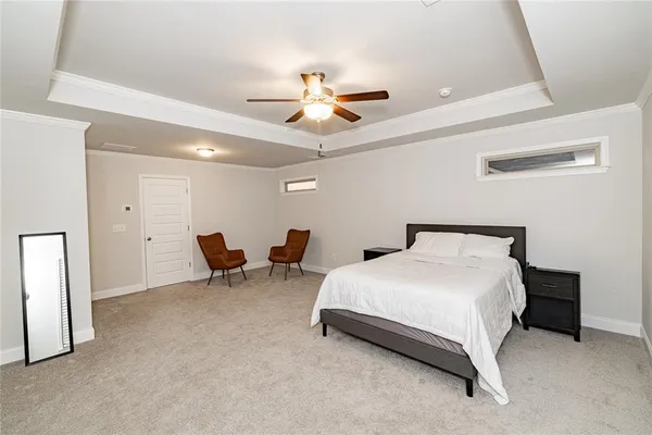a bedroom with bed and a chandelier