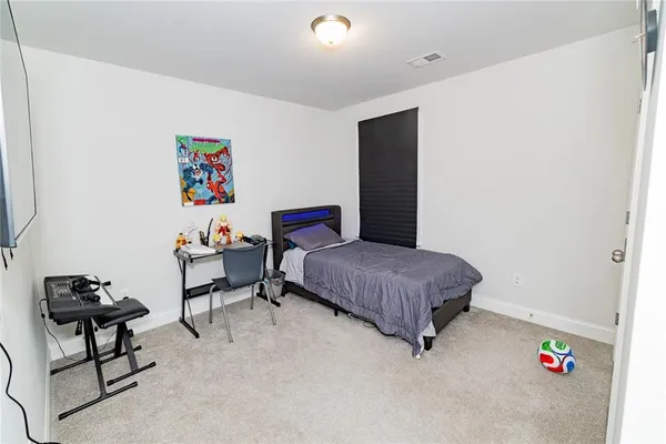 a bedroom with a bed and a bookshelf