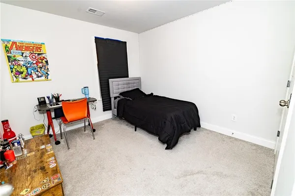 a bedroom with a bed and a chair