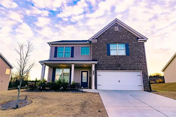 a front view of a house with a yard