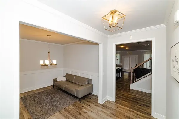 a living room with furniture and a chandelier
