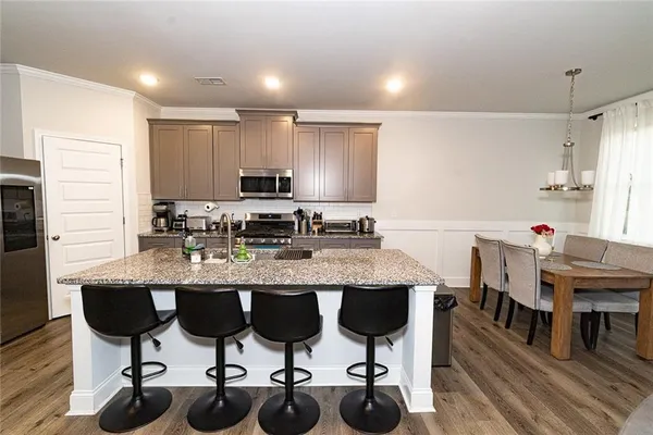 a kitchen with cabinets table and chairs