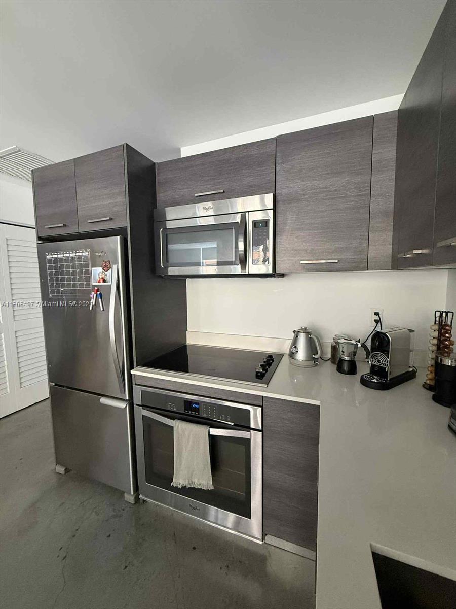 a kitchen with stainless steel appliances and cabinets