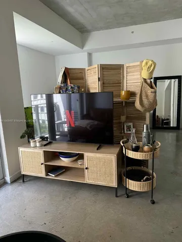 a living room with furniture and a mirror