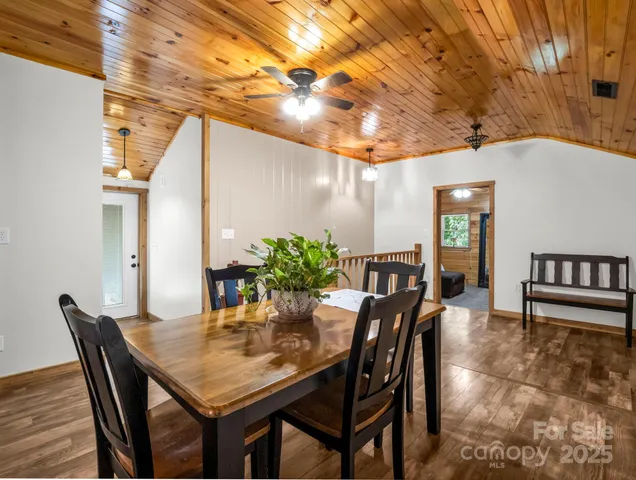 a dining room with furniture and wooden floor