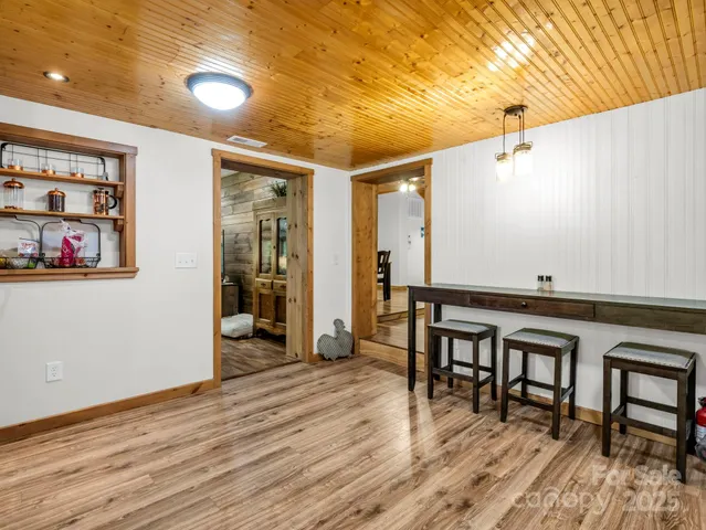 a view of a room with wooden floor and furniture
