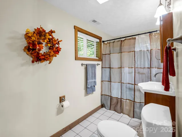 a bathroom with a sink mirror vanity and toilet