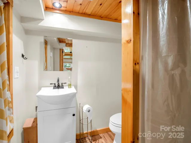 a bathroom with a sink mirror vanity and toilet