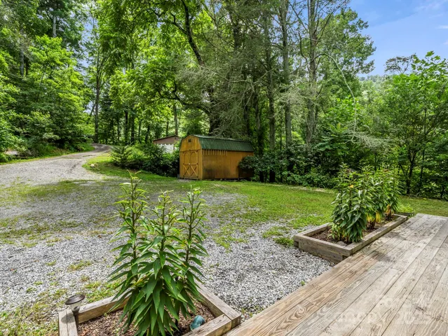 a view of backyard with a barn and a swing chair