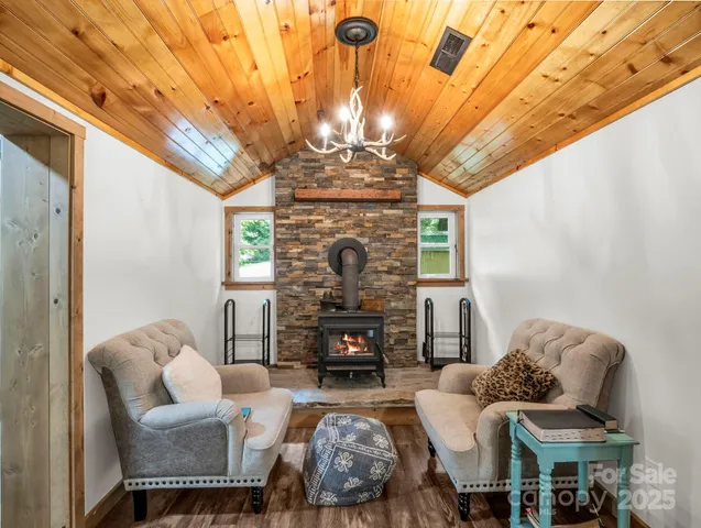 a living room with furniture a fireplace and a chandelier