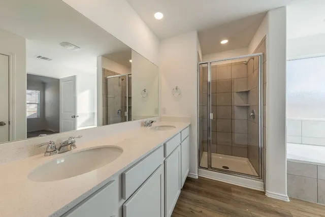 a bathroom with a bathtub and shower