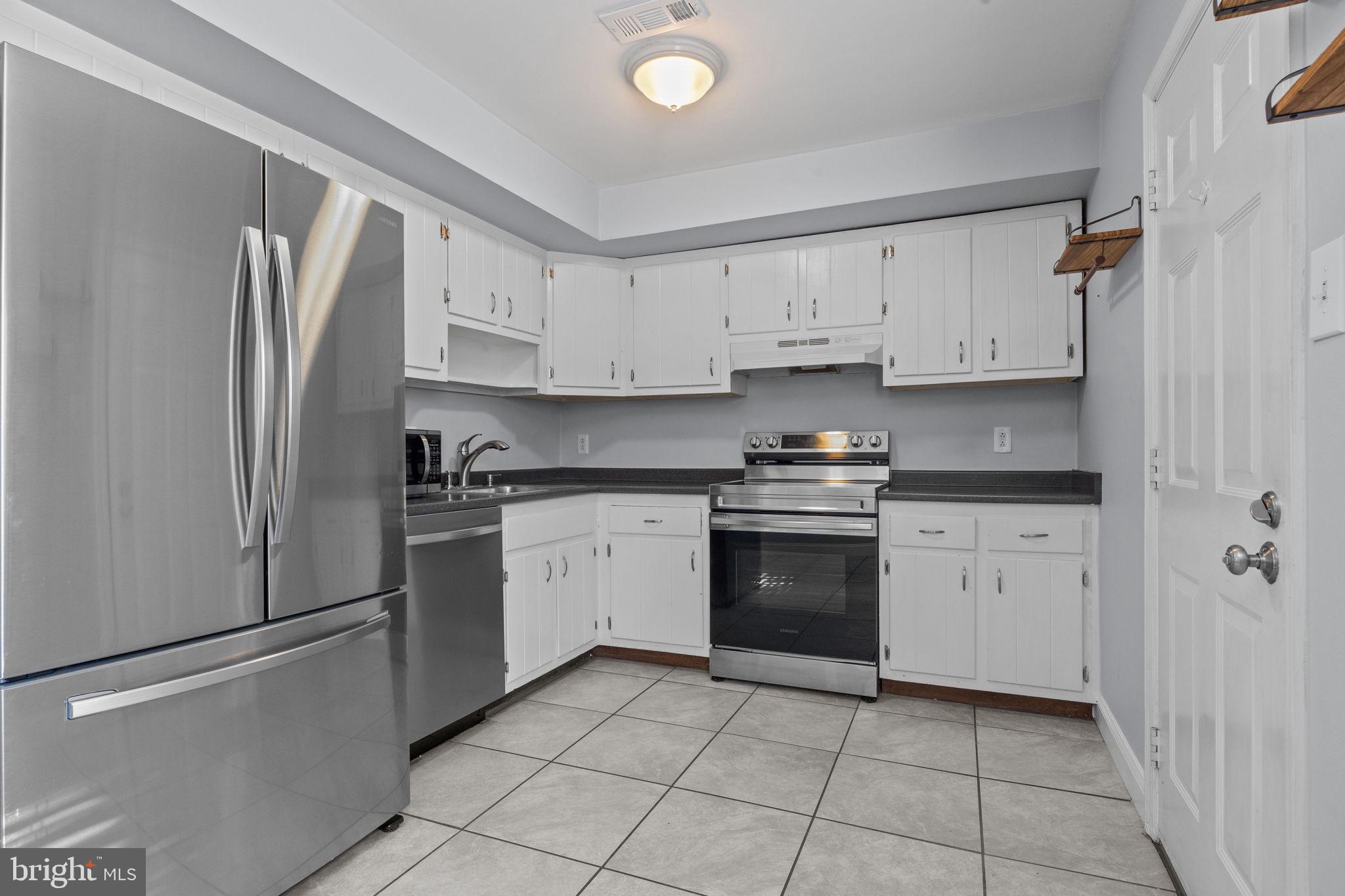 1006 North York Road, Unit 1 Willow Grove, PA 19090 - Photo 12 of 26 a kitchen with cabinets stainless steel appliances and a counter space