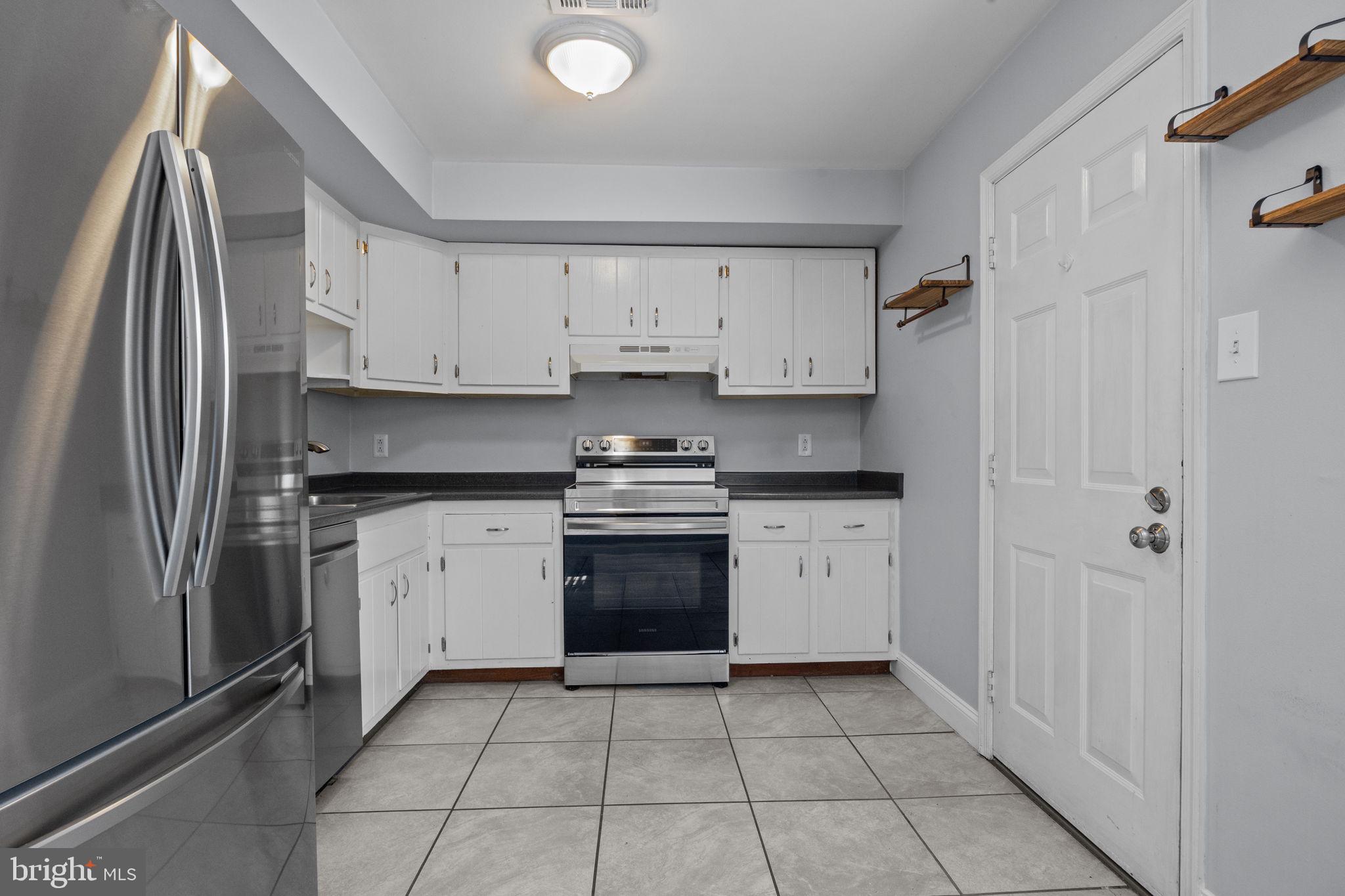 1006 North York Road, Unit 1 Willow Grove, PA 19090 - Photo 13 of 26 a kitchen with stainless steel appliances granite countertop a refrigerator and a stove