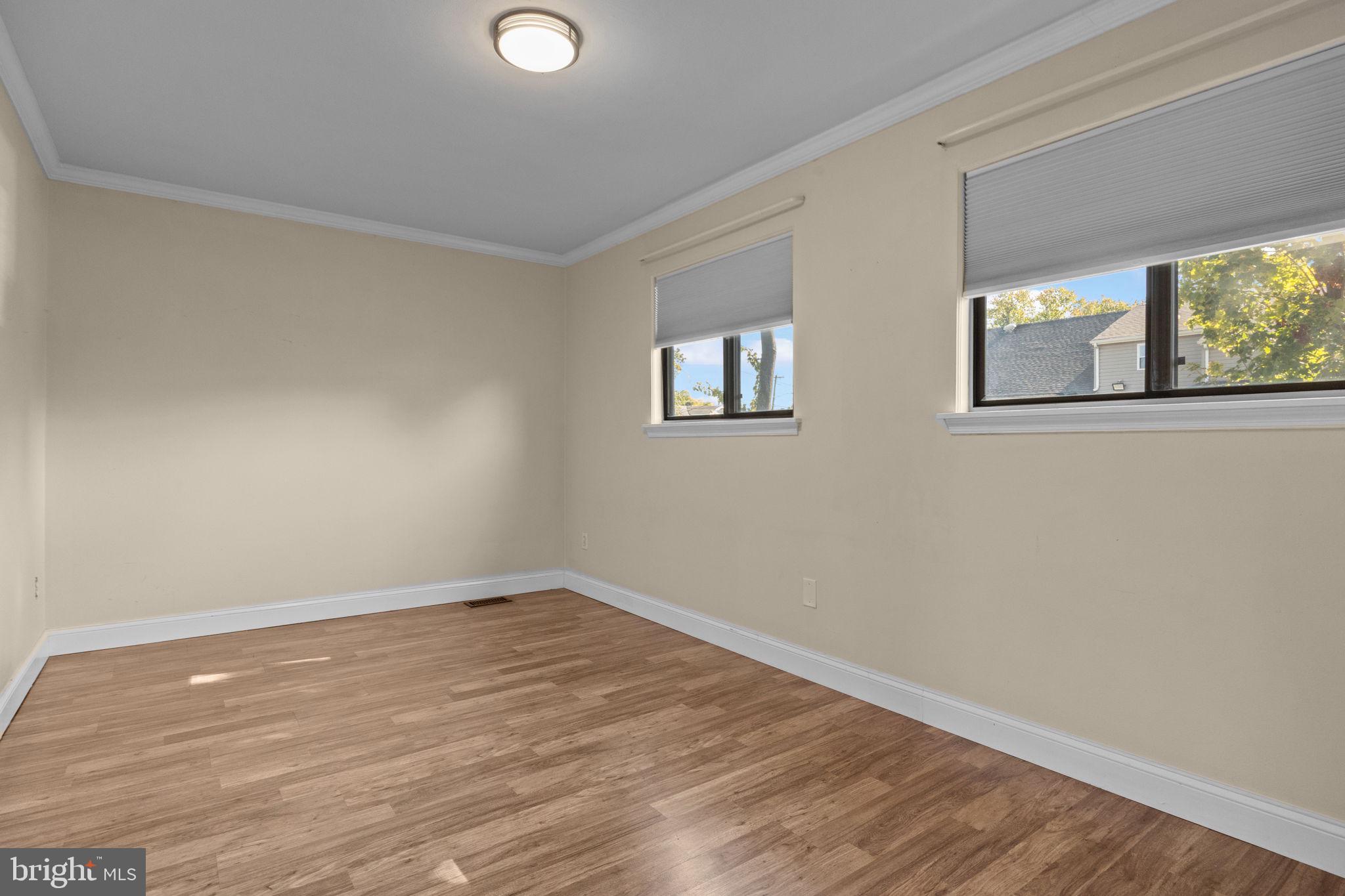 1006 North York Road, Unit 1 Willow Grove, PA 19090 - Photo 18 of 26 a view of an empty room with wooden floor and a window