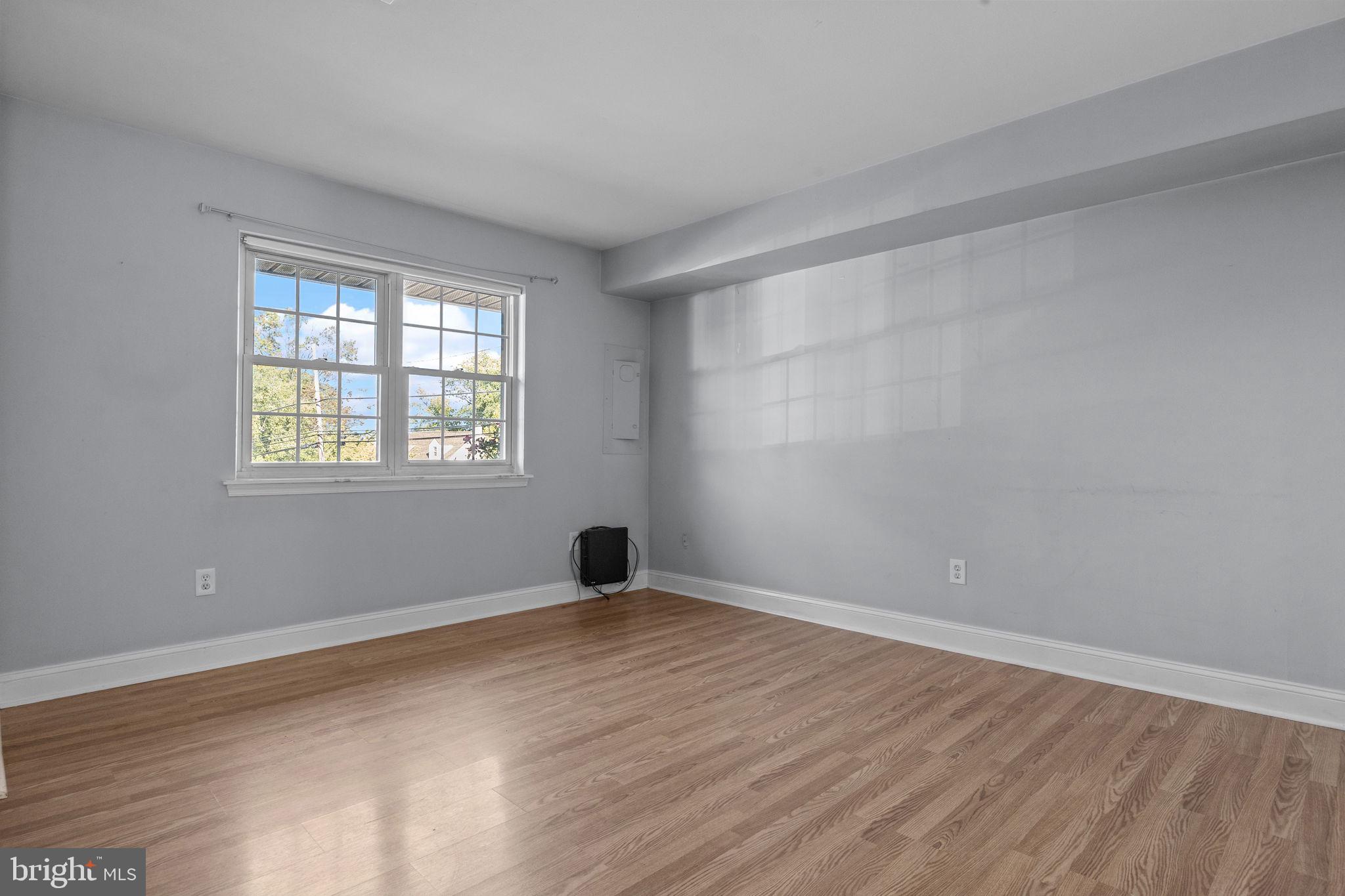 1006 North York Road, Unit 1 Willow Grove, PA 19090 - Photo 6 of 26 a view of an empty room with wooden floor and a window
