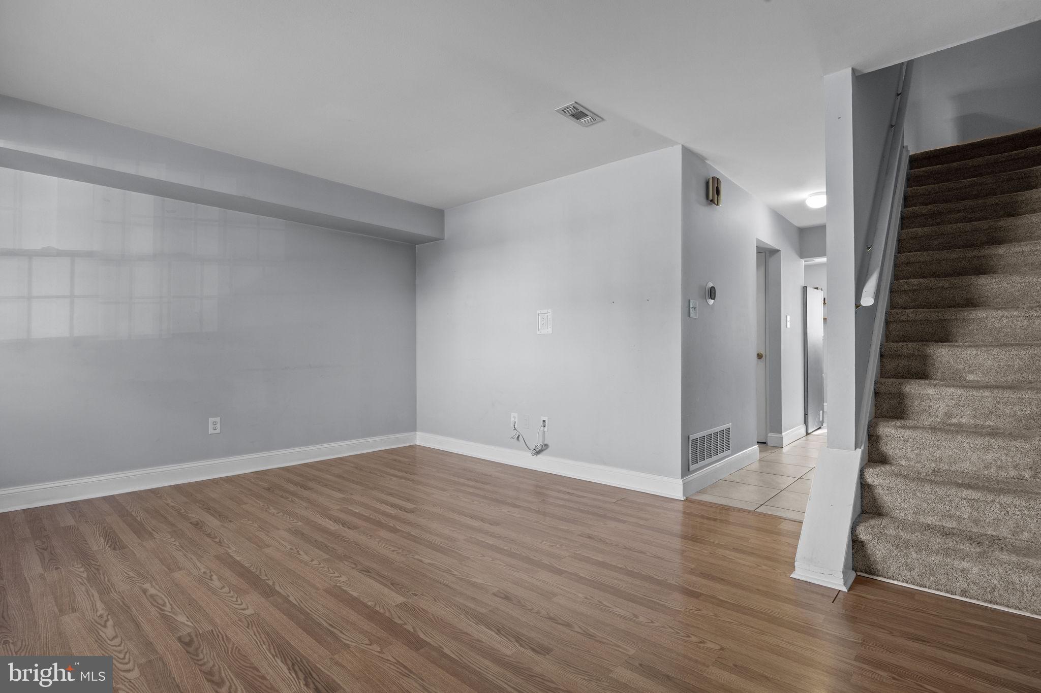 1006 North York Road, Unit 1 Willow Grove, PA 19090 - Photo 7 of 26 a view of an empty room with wooden floor and stairs