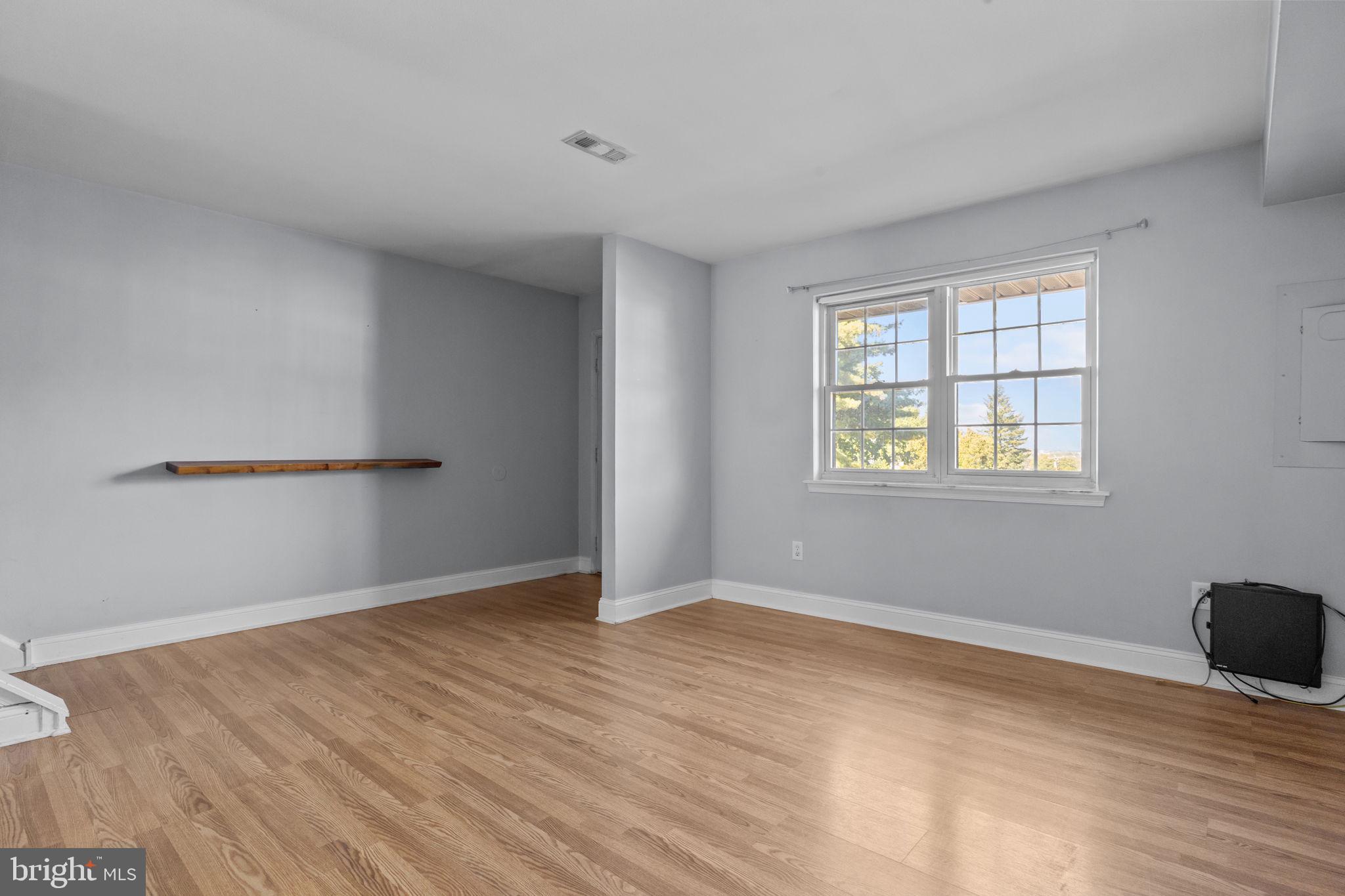 1006 North York Road, Unit 1 Willow Grove, PA 19090 - Photo 8 of 26 a view of an empty room with wooden floor and a window