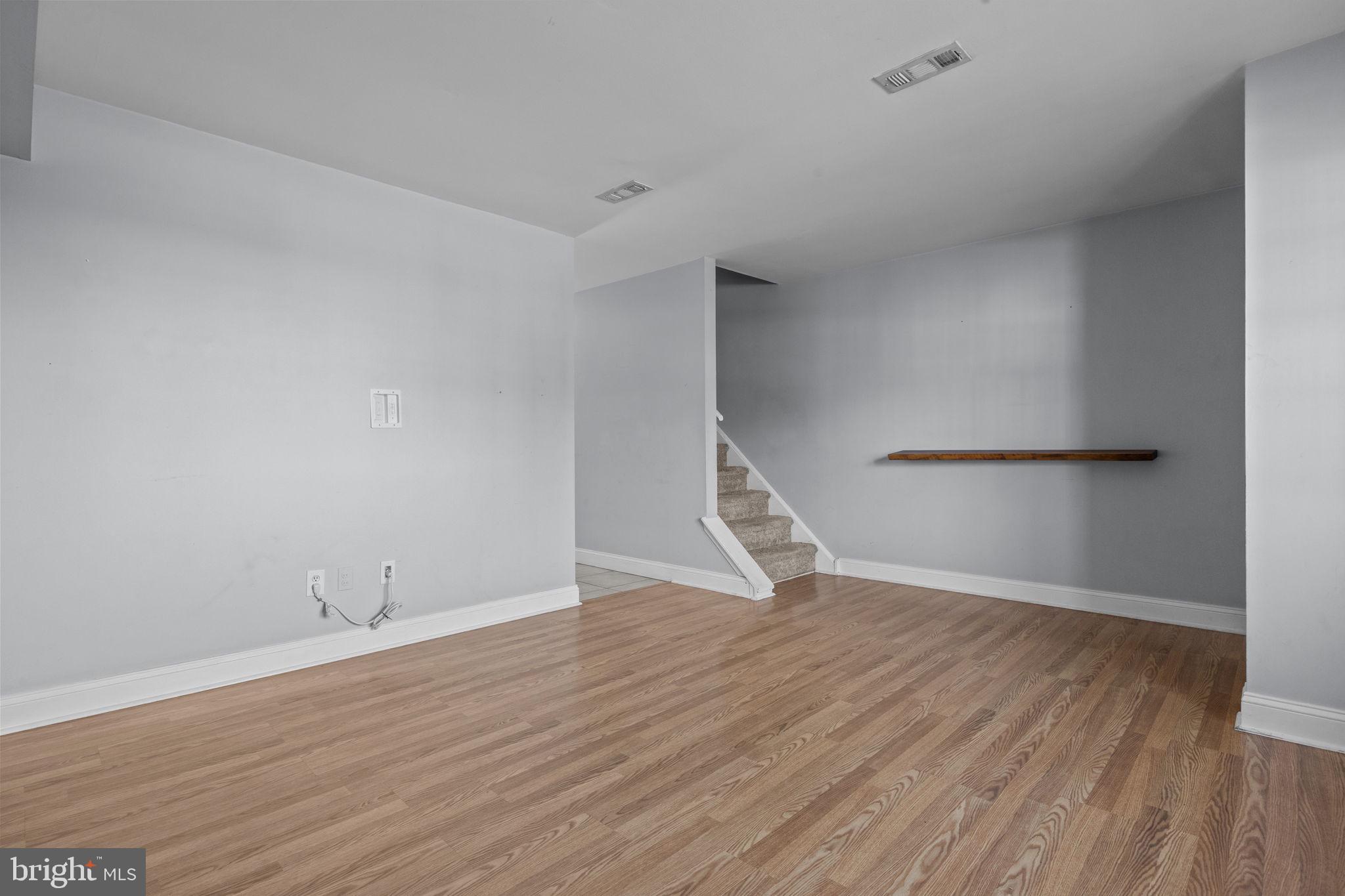 1006 North York Road, Unit 1 Willow Grove, PA 19090 - Photo 9 of 26 a view of an empty room with wooden floor and a window