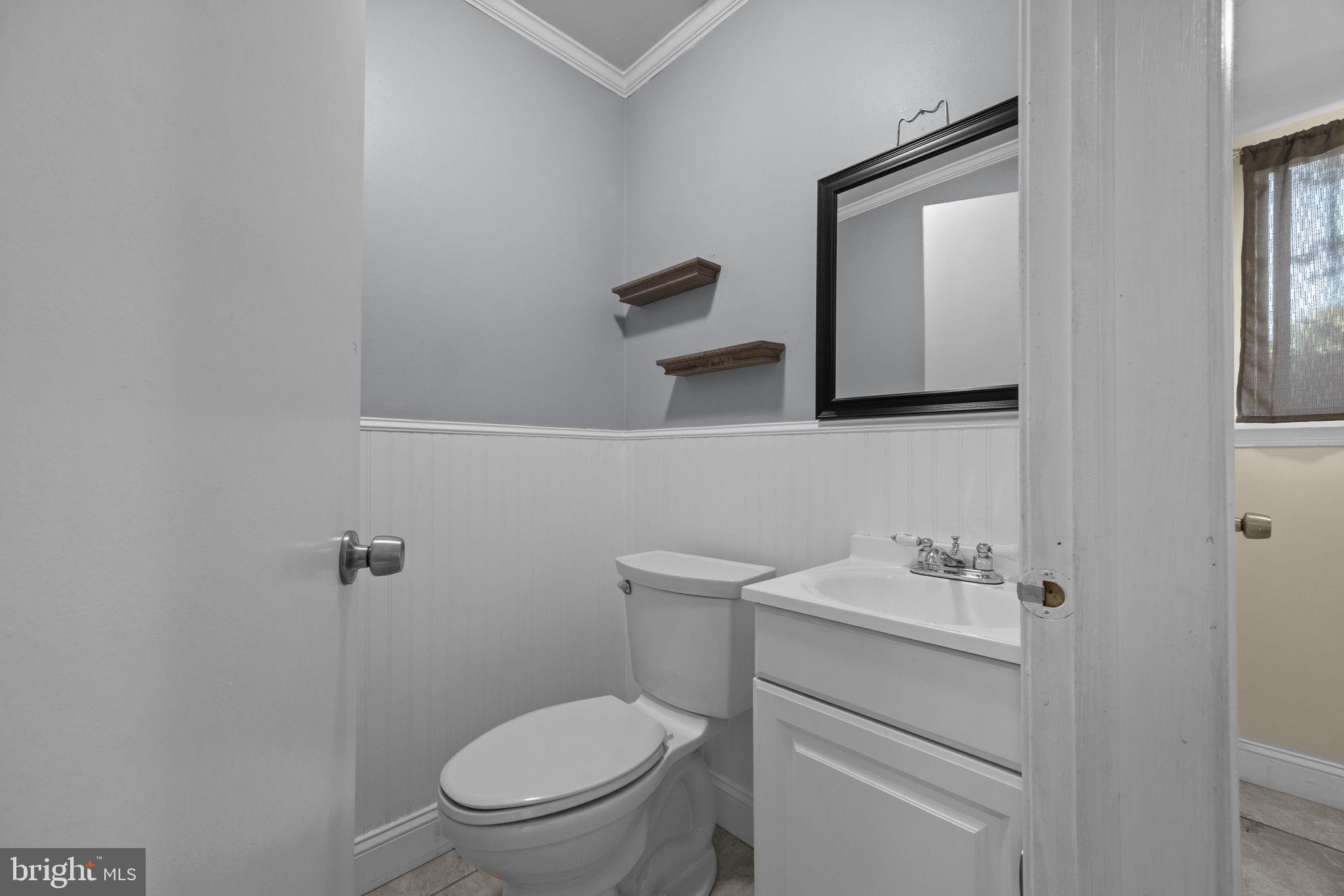 1006 North York Road, Unit 1 Willow Grove, PA 19090 - Photo 10 of 26 a bathroom with a toilet sink vanity and mirror
