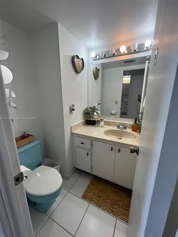 a bathroom with a double vanity sink mirror and toilet