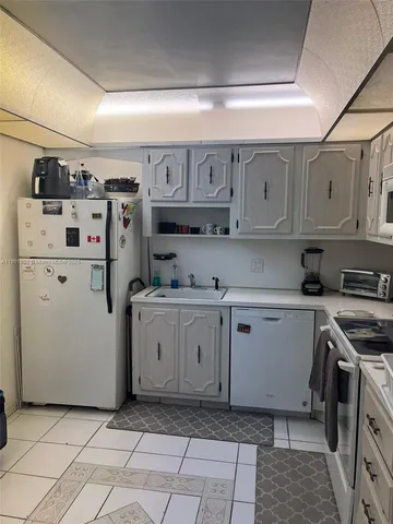 a kitchen with cabinets and window