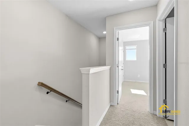 a view of a hallway with closet and mirror